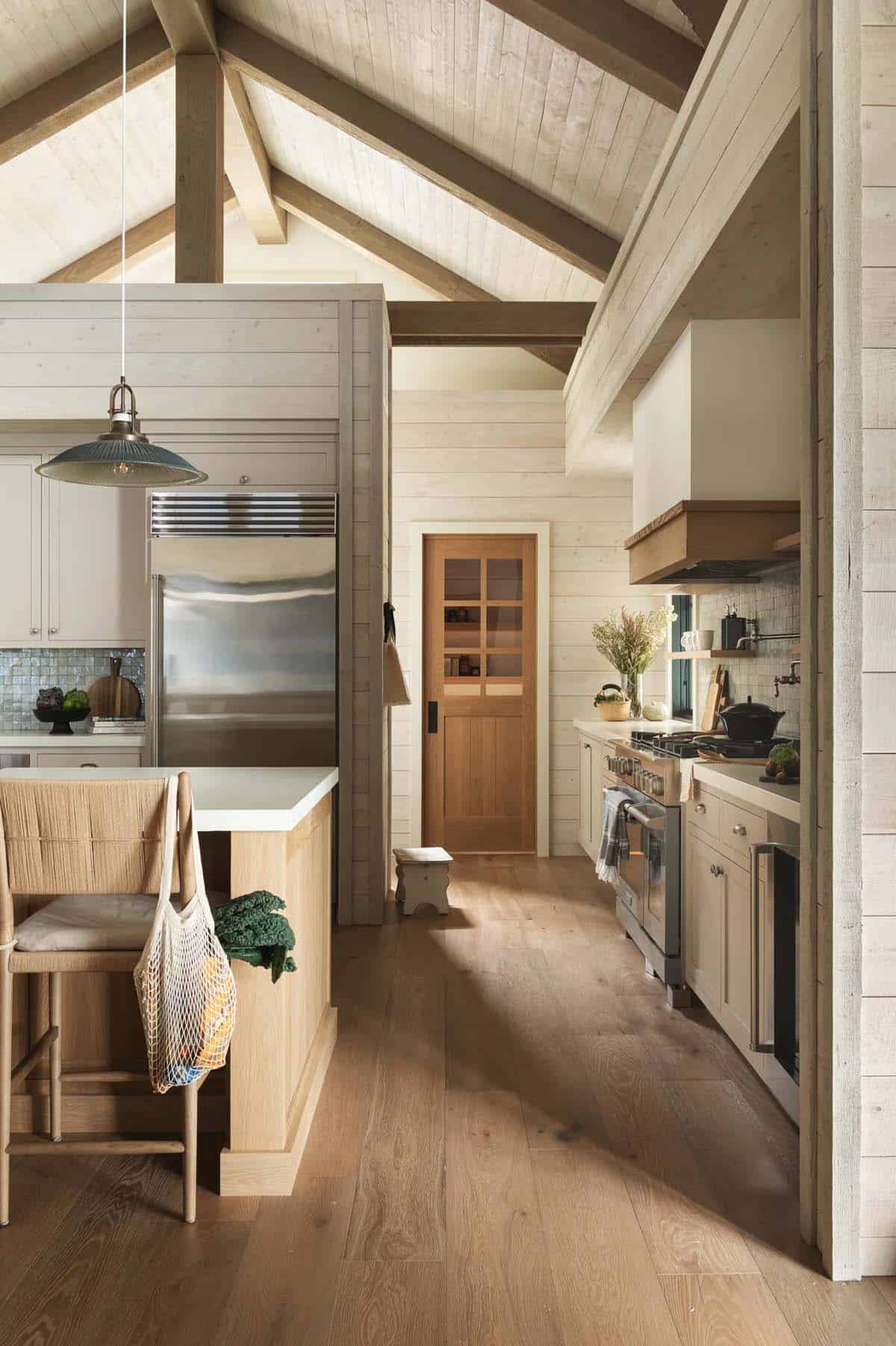 Kitchen hallway with vaulted ceiling and paneled door