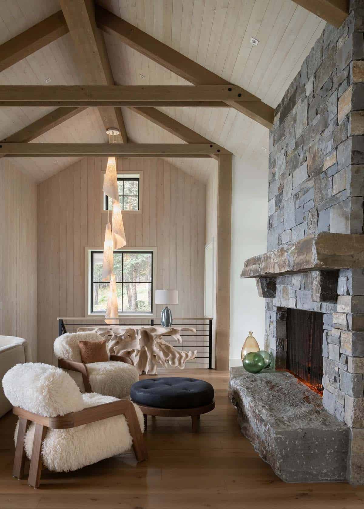 Living room stone fireplace with shearling lounge chairs