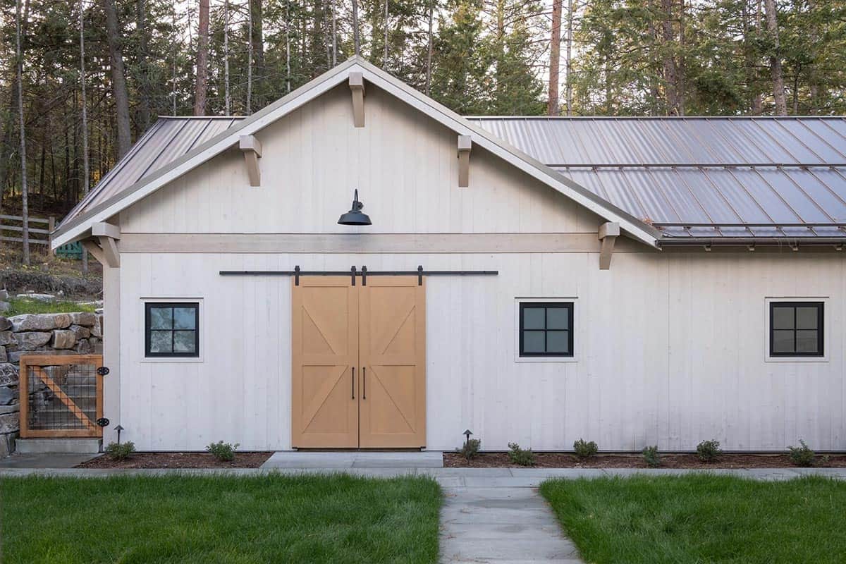 Barn-style garage with sliding wood doors and metal roof