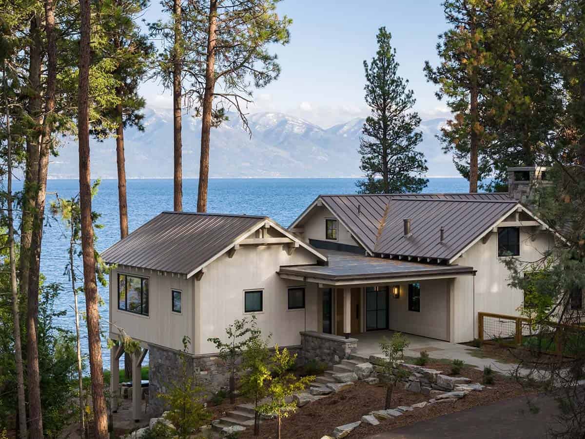 Aerial exterior view of the lake house with mountain backdrop