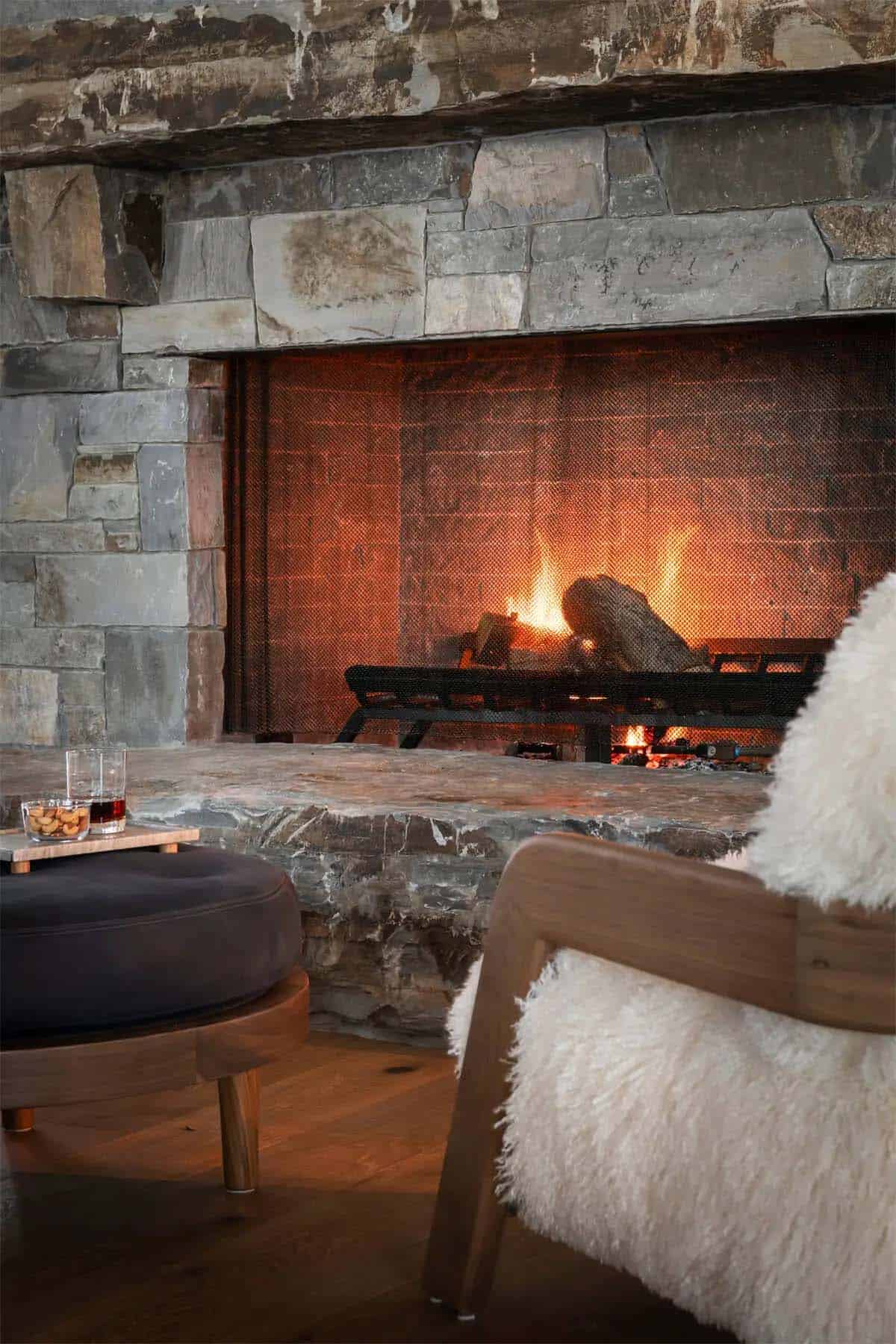 Stone fireplace detail with cozy seating nearby