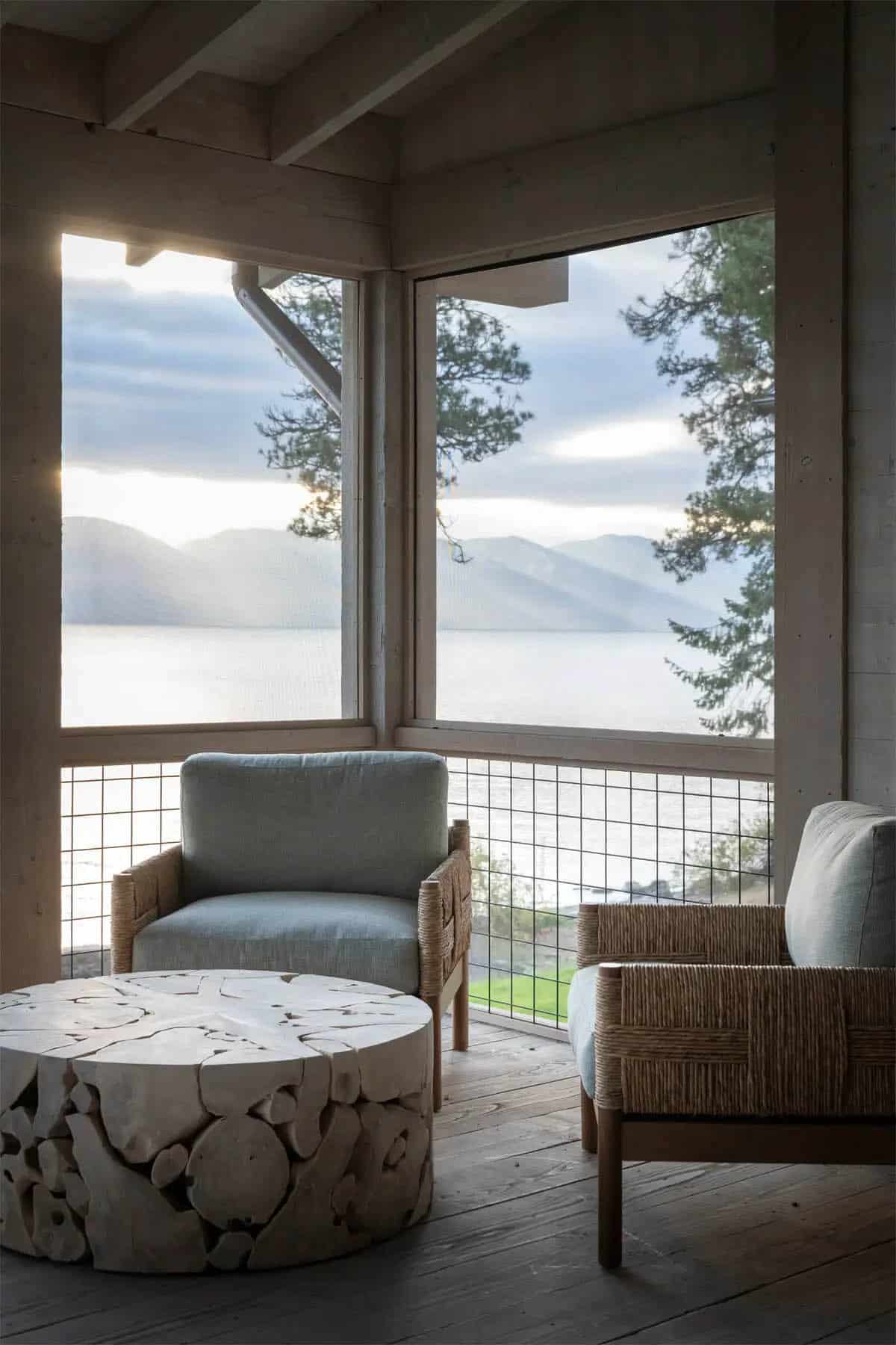 Screened porch corner with woven chairs and lake view