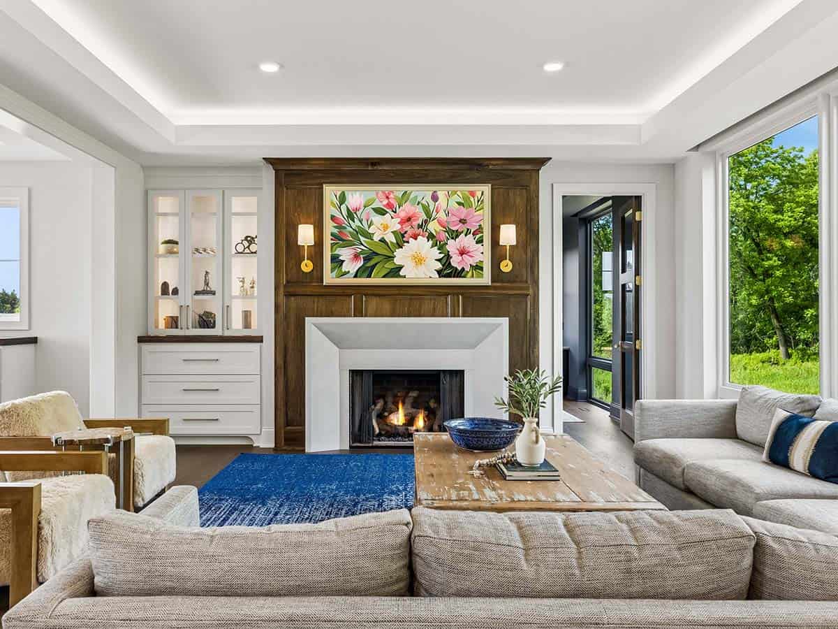 Living room fireplace with built-in cabinetry and floral artwork