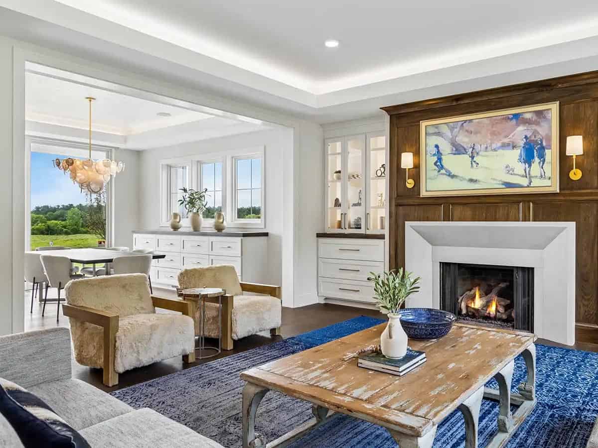 Living room with shearling chairs opening to dining area