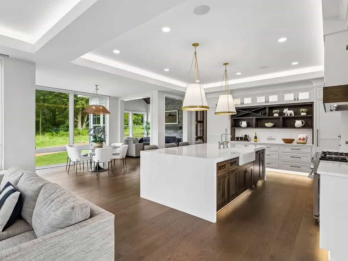 Kitchen island with waterfall countertop and built-in display shelving