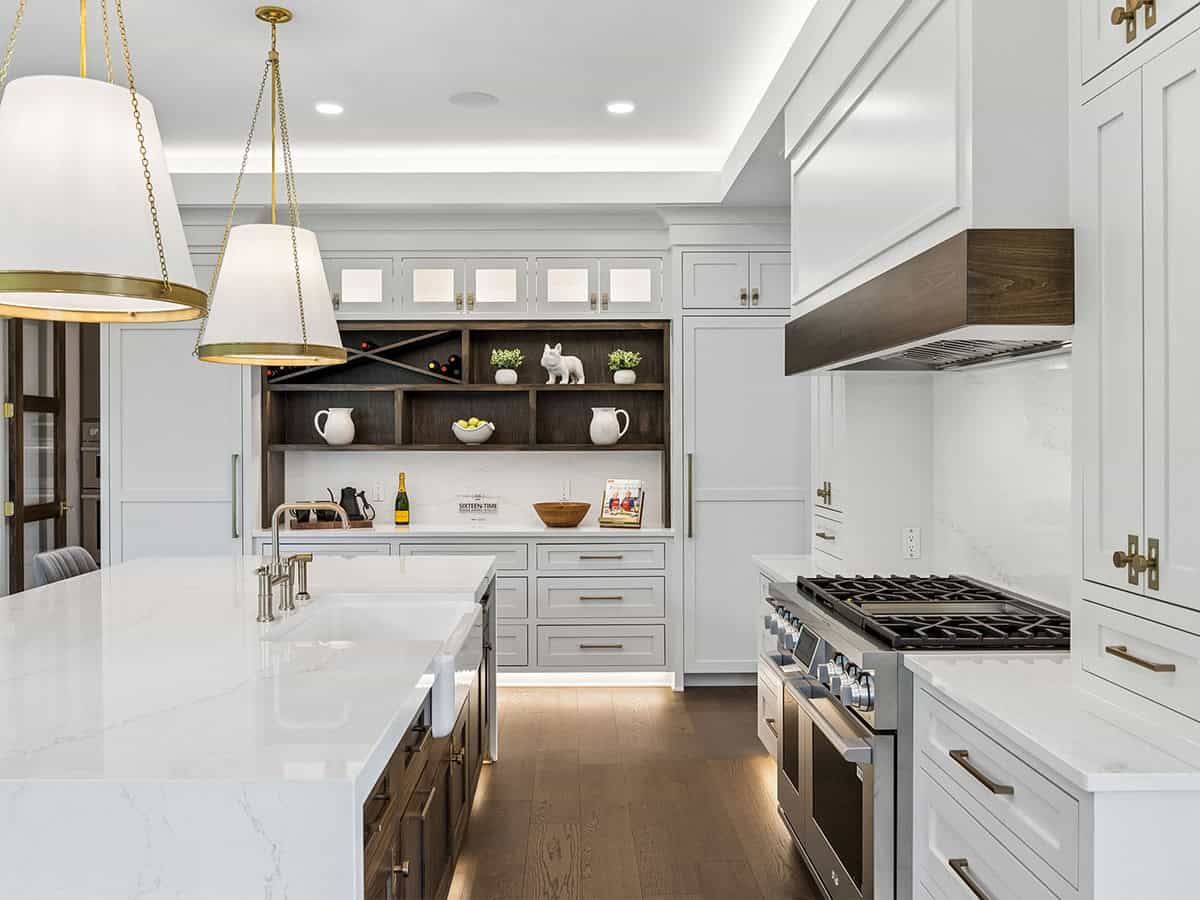 Close-up of kitchen range and open wood shelving with brass hardware