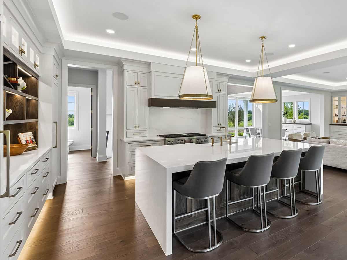 Kitchen island with gray bar stools and pendant lighting