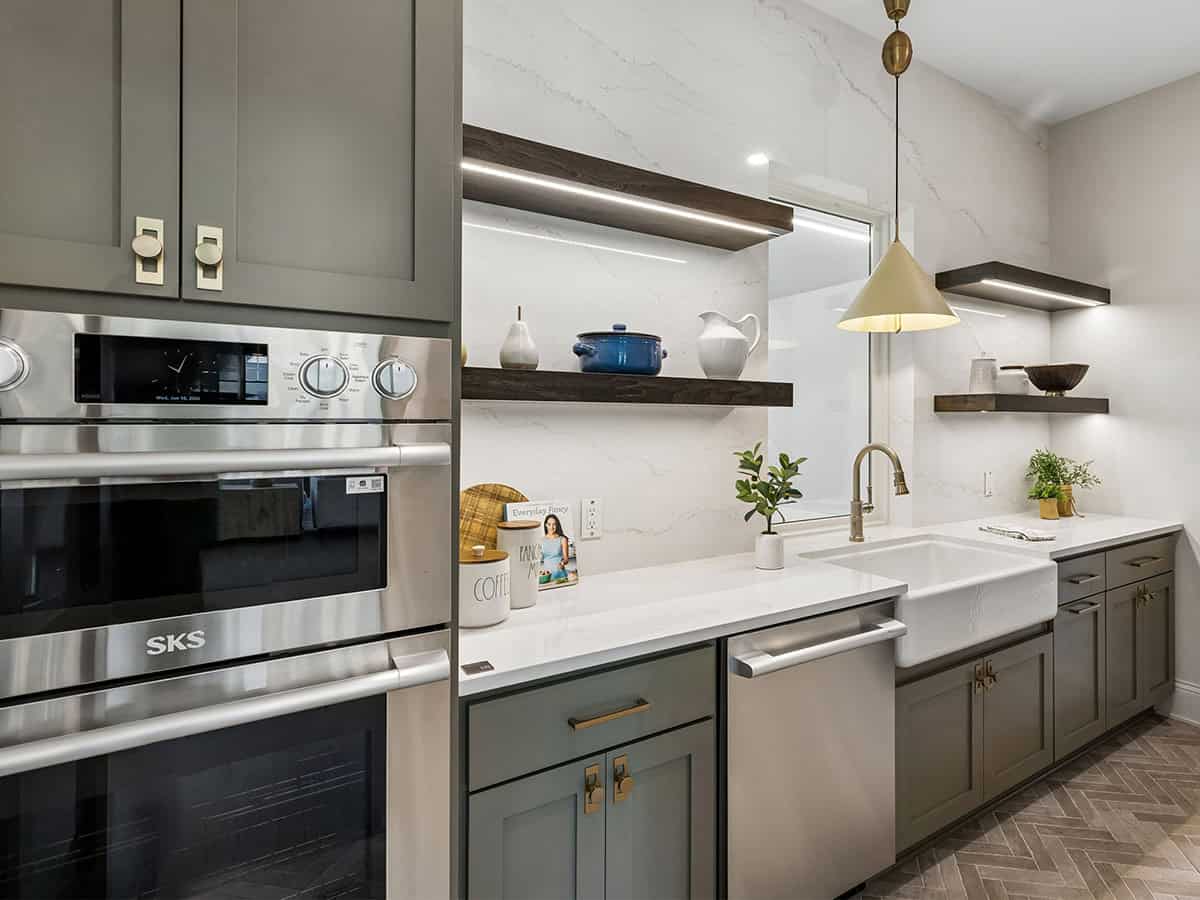 Butler's pantry with stainless double oven and floating wood shelves