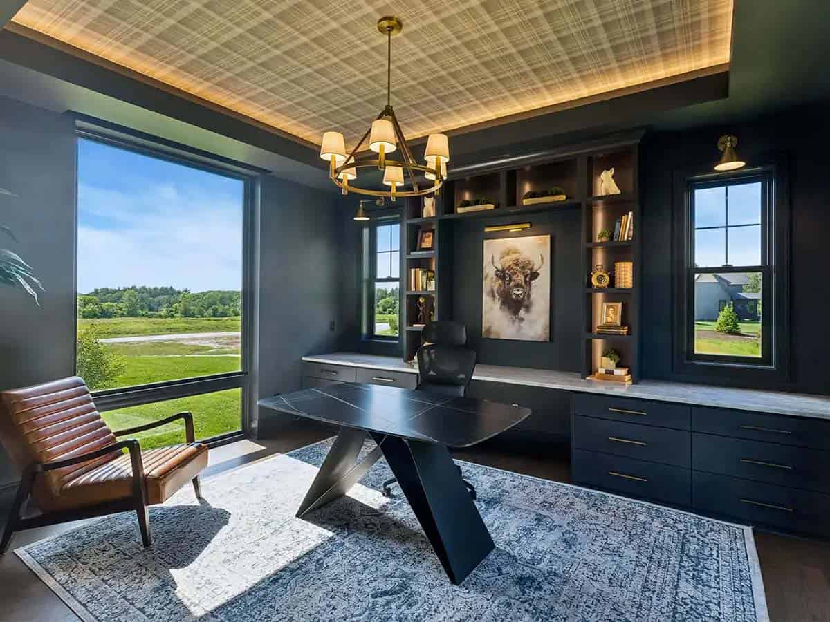 Home office with navy built-ins, plaid ceiling, and angular desk