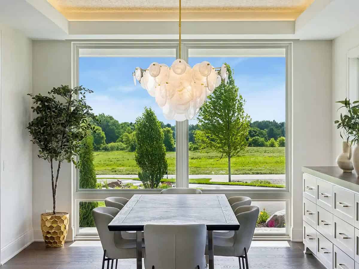 Formal dining room with bubble glass chandelier and tree view
