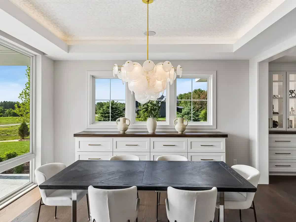 Dining room with black wood table and white upholstered chairs