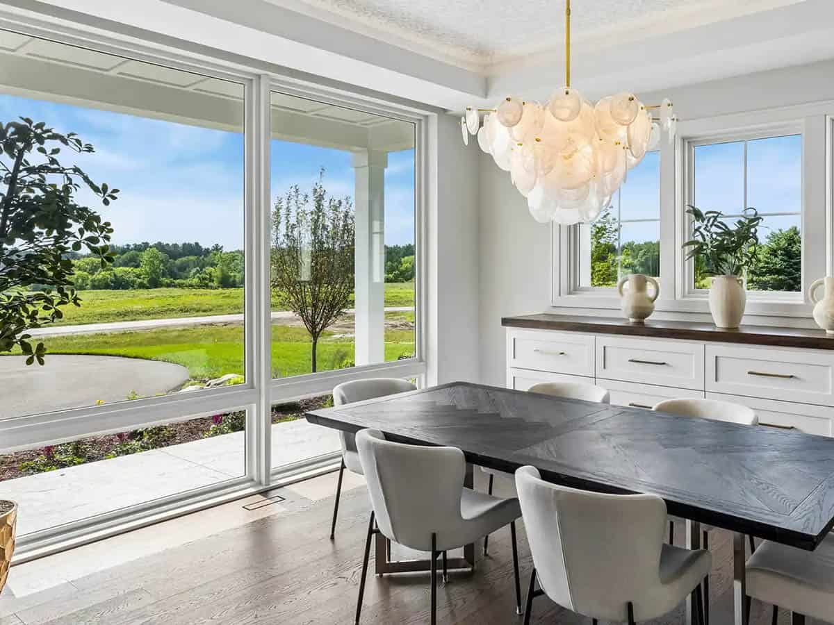 Dining room with covered patio view through floor-to-ceiling windows