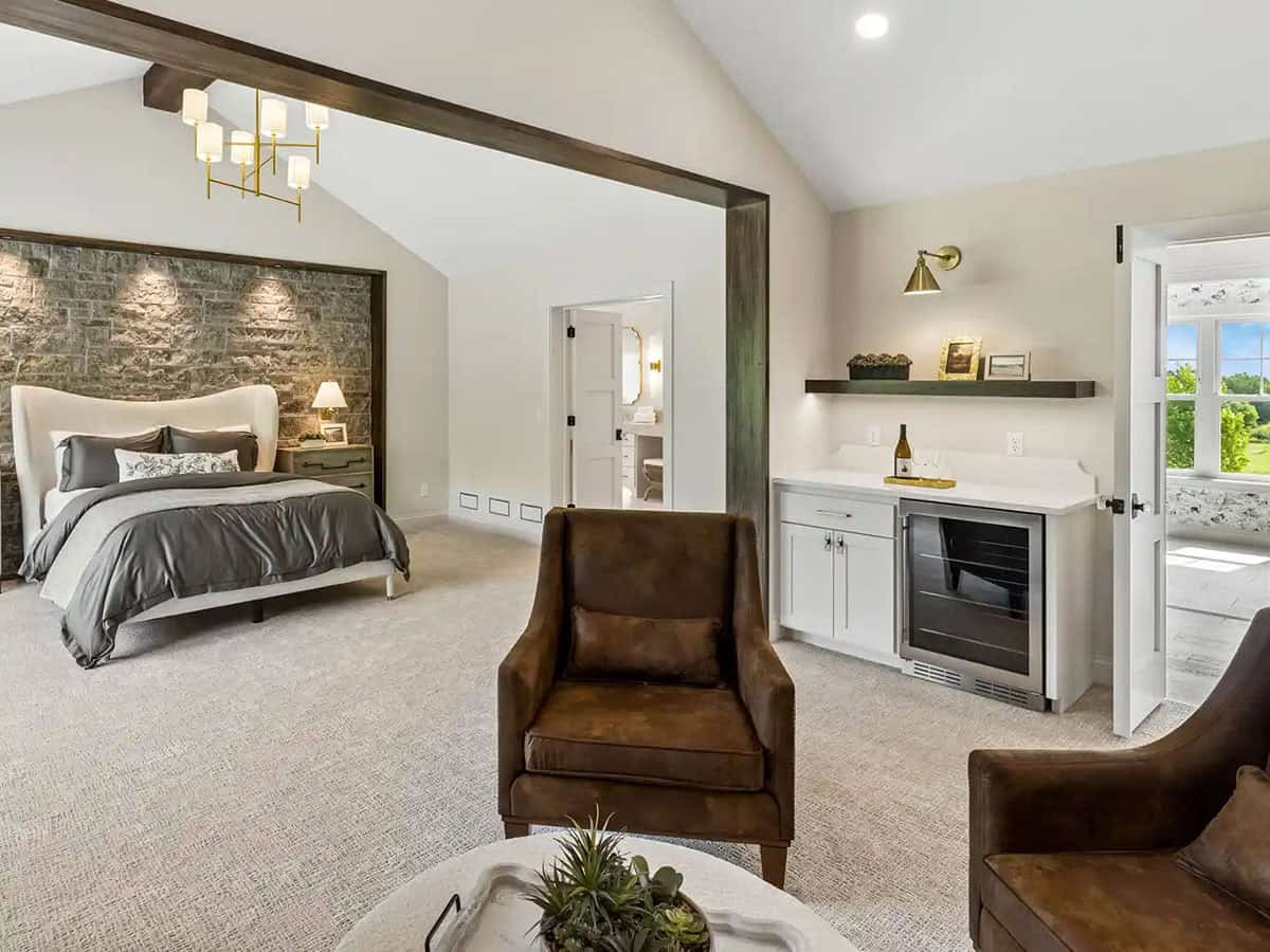 Primary suite sitting area with leather chairs and built-in beverage bar