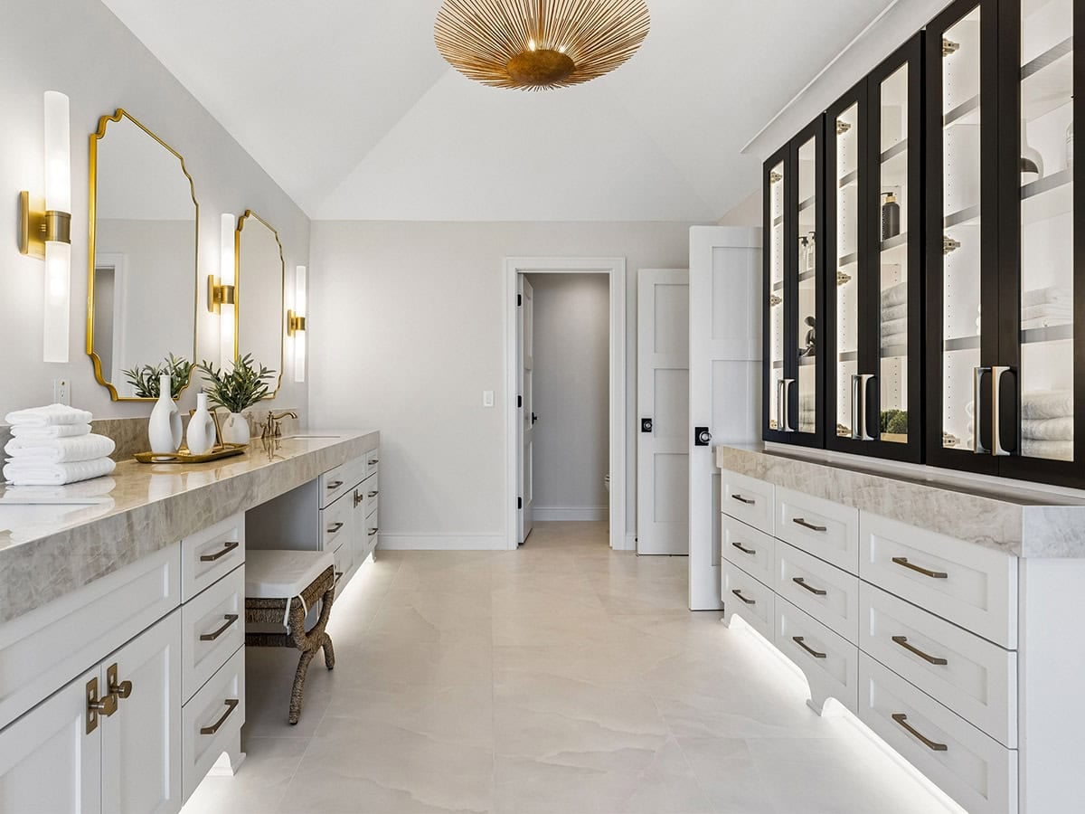 Bathroom with double vanity and black-framed glass display cabinets