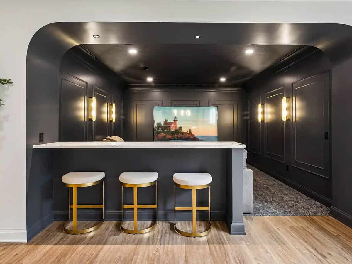 Home theater alcove with marble bar and lighthouse art on screen