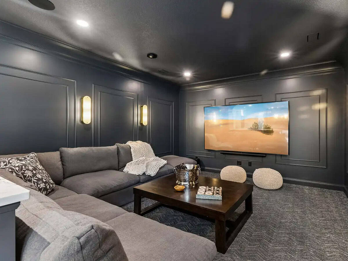 Media room with gray paneled walls and sectional sofa