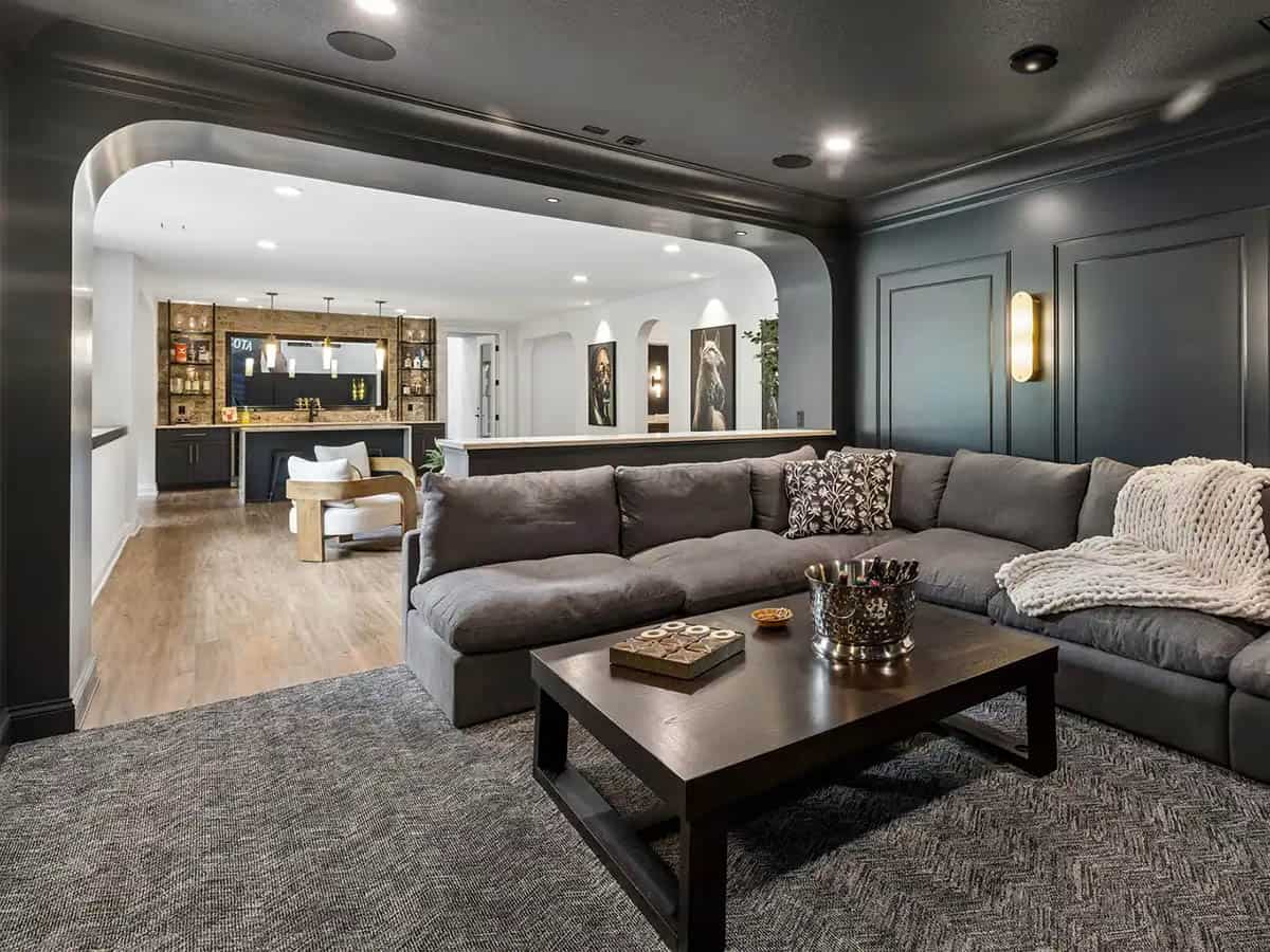 Lower-level lounge opening to stone-accented bar area