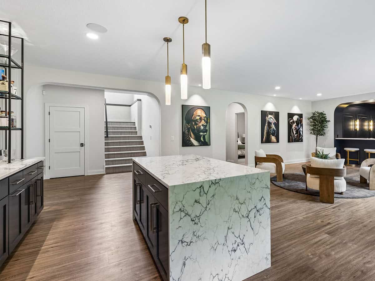 Lower-level marble island with staircase and gallery wall beyond
