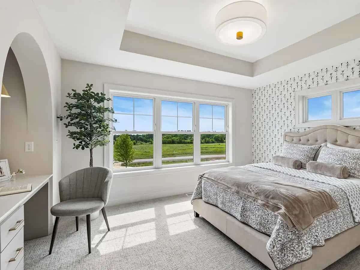Bedroom with floral wallpaper accent and arched reading nook