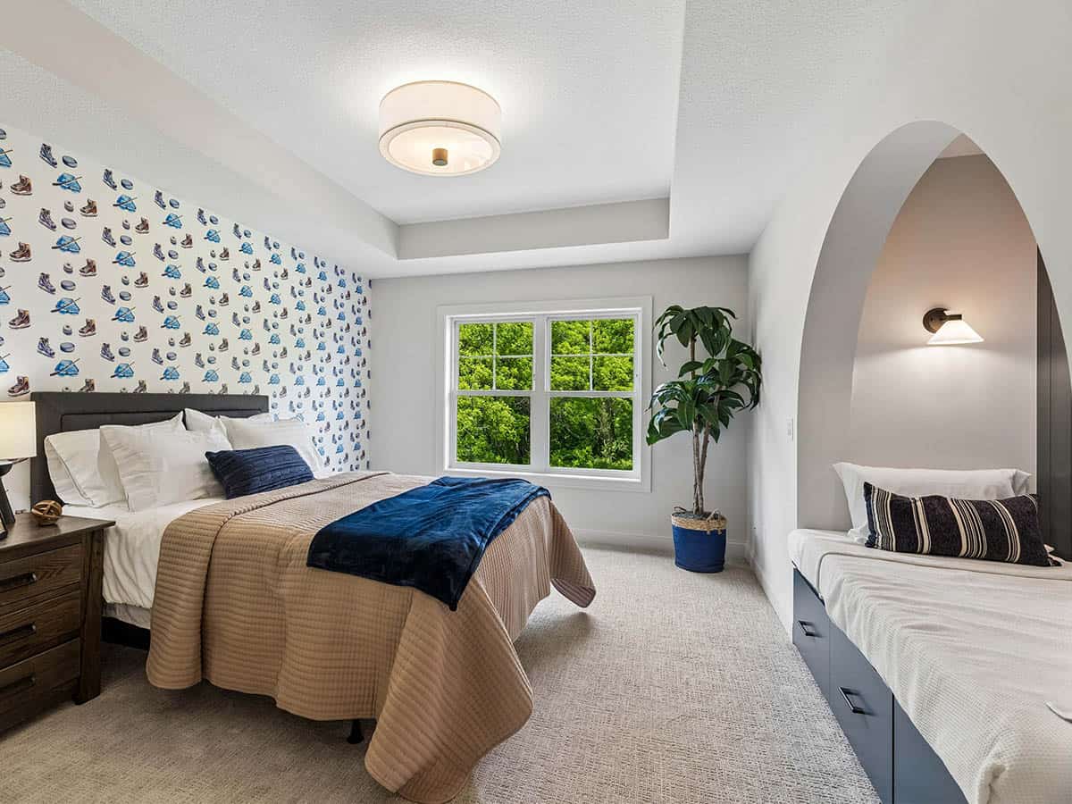 Bedroom with hockey-print wallpaper and built-in daybed nook