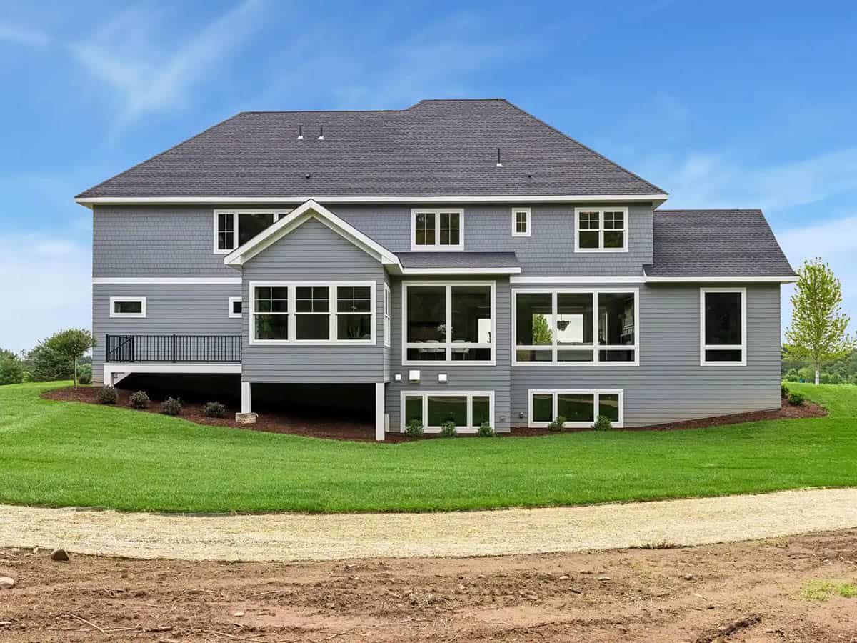 Rear exterior view showing elevated deck and walkout windows