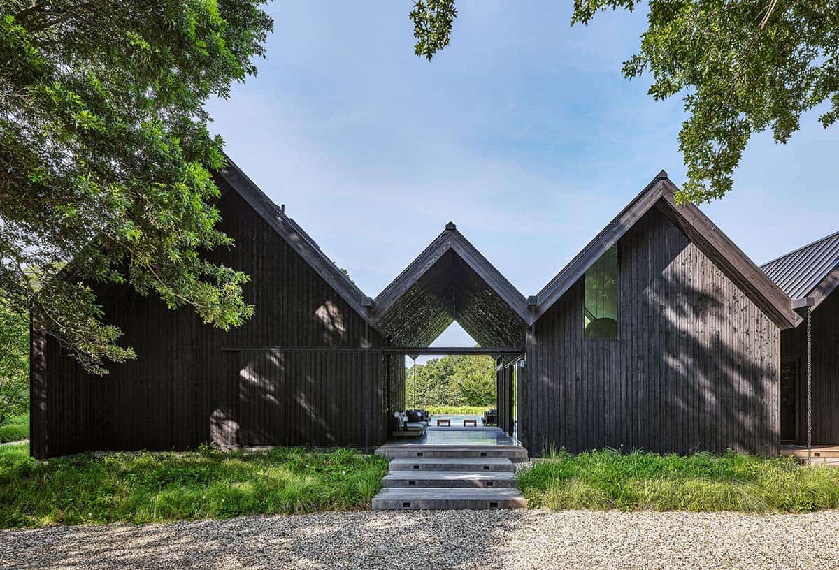 Symmetrical view through the home's central breezeway framing the pool and lounge furniture beyond