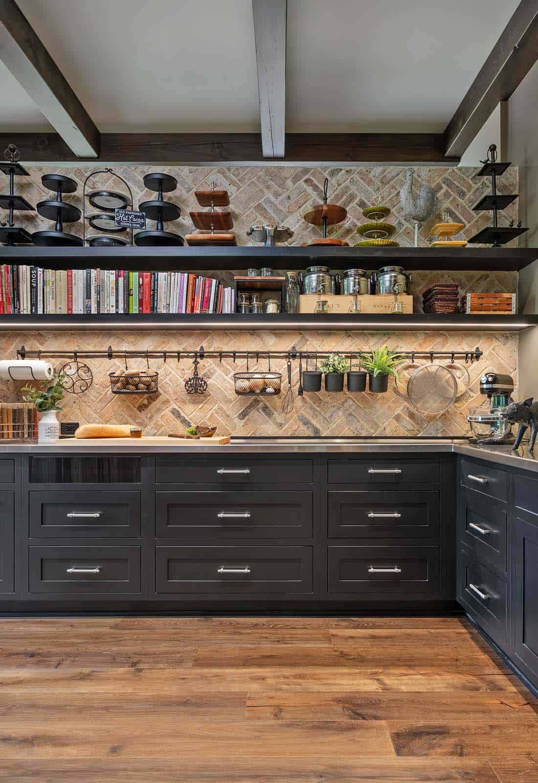 Butler's pantry with dark navy cabinets, herringbone brick backsplash, and open shelving with cookbooks