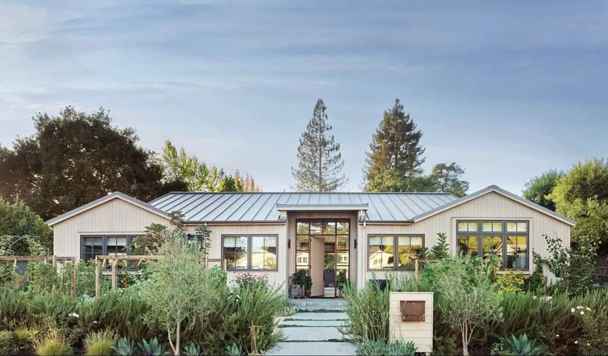 Lush edible front yard landscape with mixed plantings and a stepping stone path leading to a modern farmhouse in California