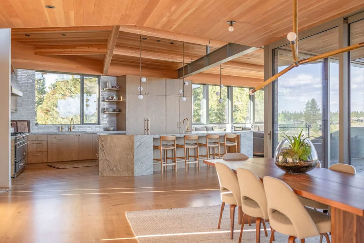 Open-plan kitchen and dining room with walnut table and views of high desert landscape