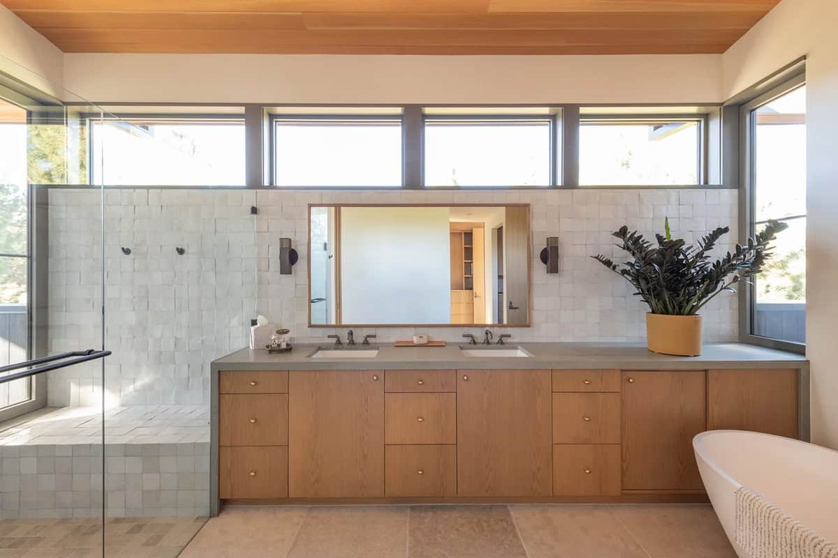 Primary bathroom with zellige tile, dual vanity, and clerestory windows