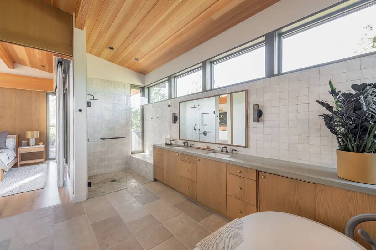 Primary bathroom with walk-in shower, dual vanity, and wood ceiling