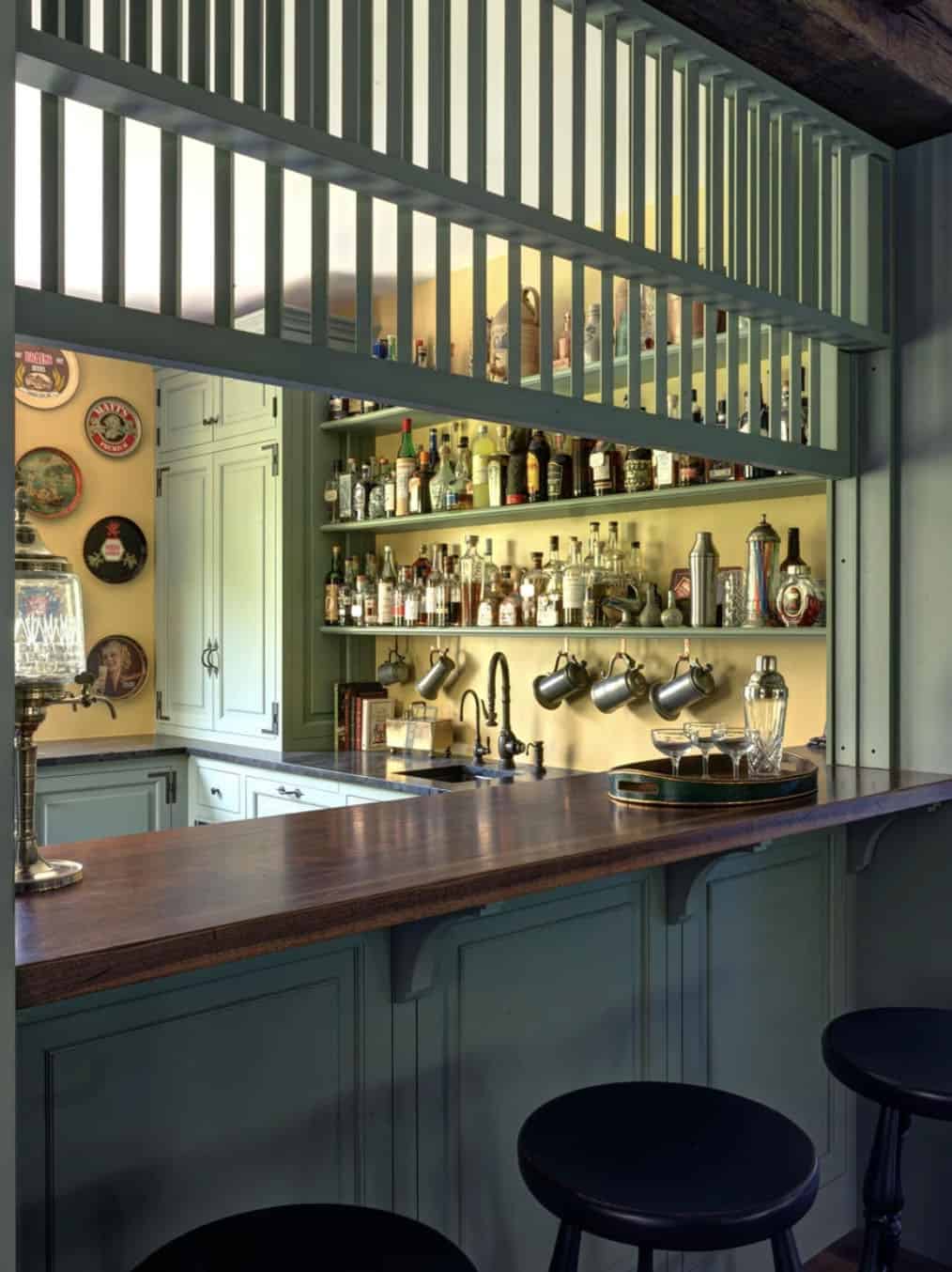 Bar counter with wood top, slatted overhead divider, and shelved bottle display