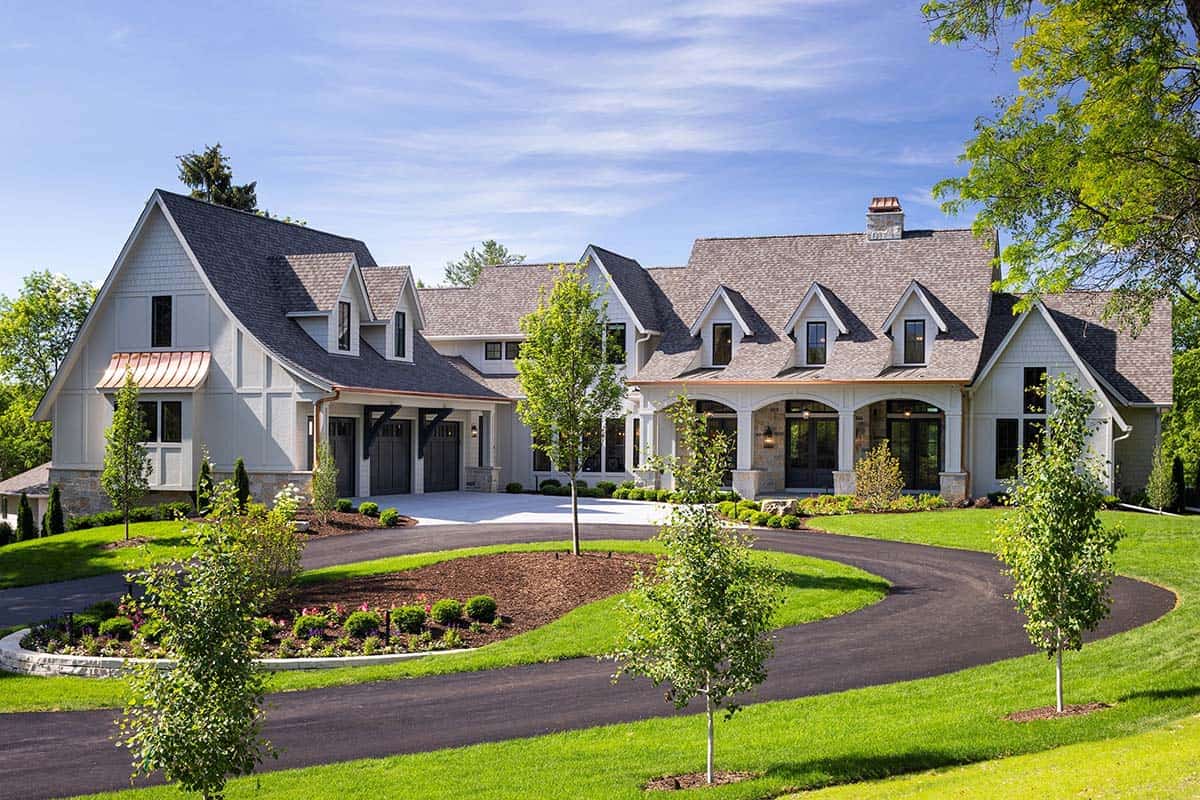 Front view of European-inspired estate with multiple dormers and three-car garage