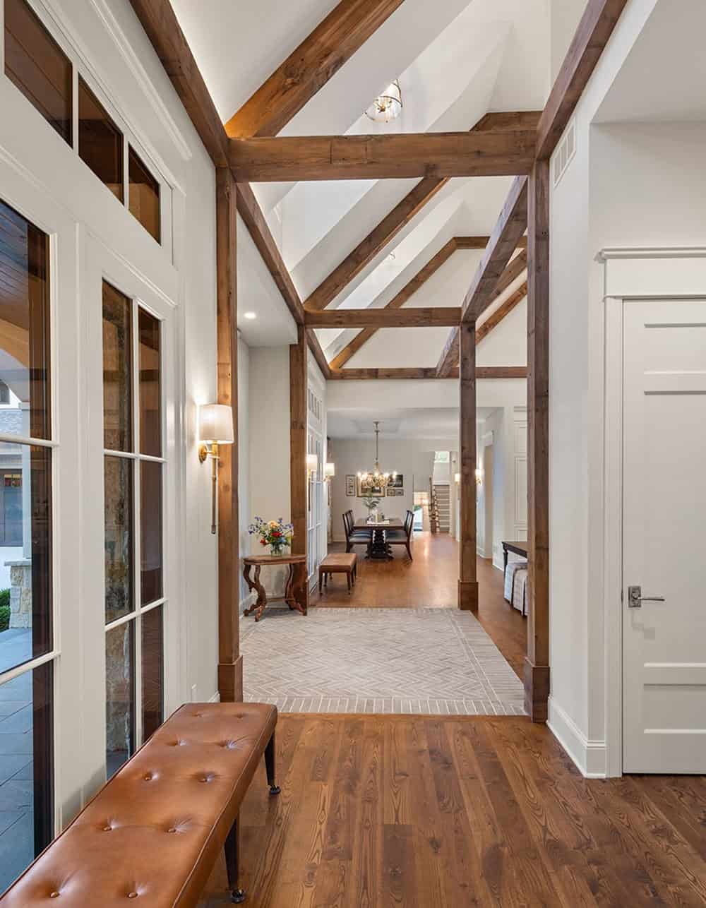 Entry hallway with crisscrossing wood beams leading to dining room