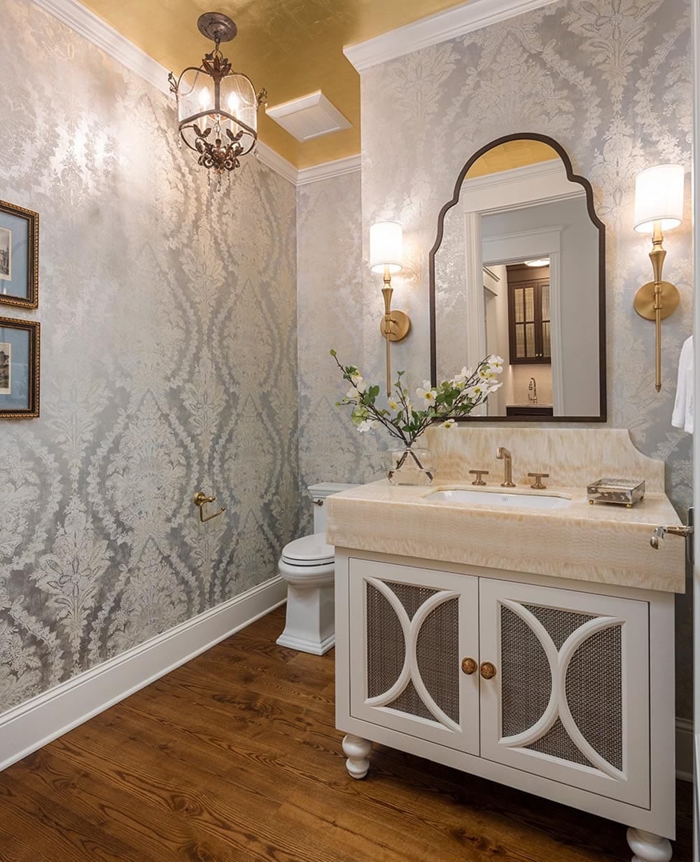 Powder room with silver damask wallpaper, gold ceiling, and onyx vanity top