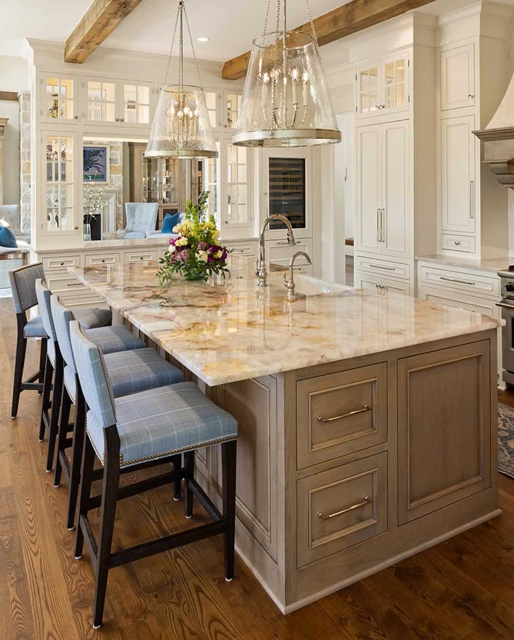 Kitchen island with marble waterfall countertop and plaid upholstered barstools