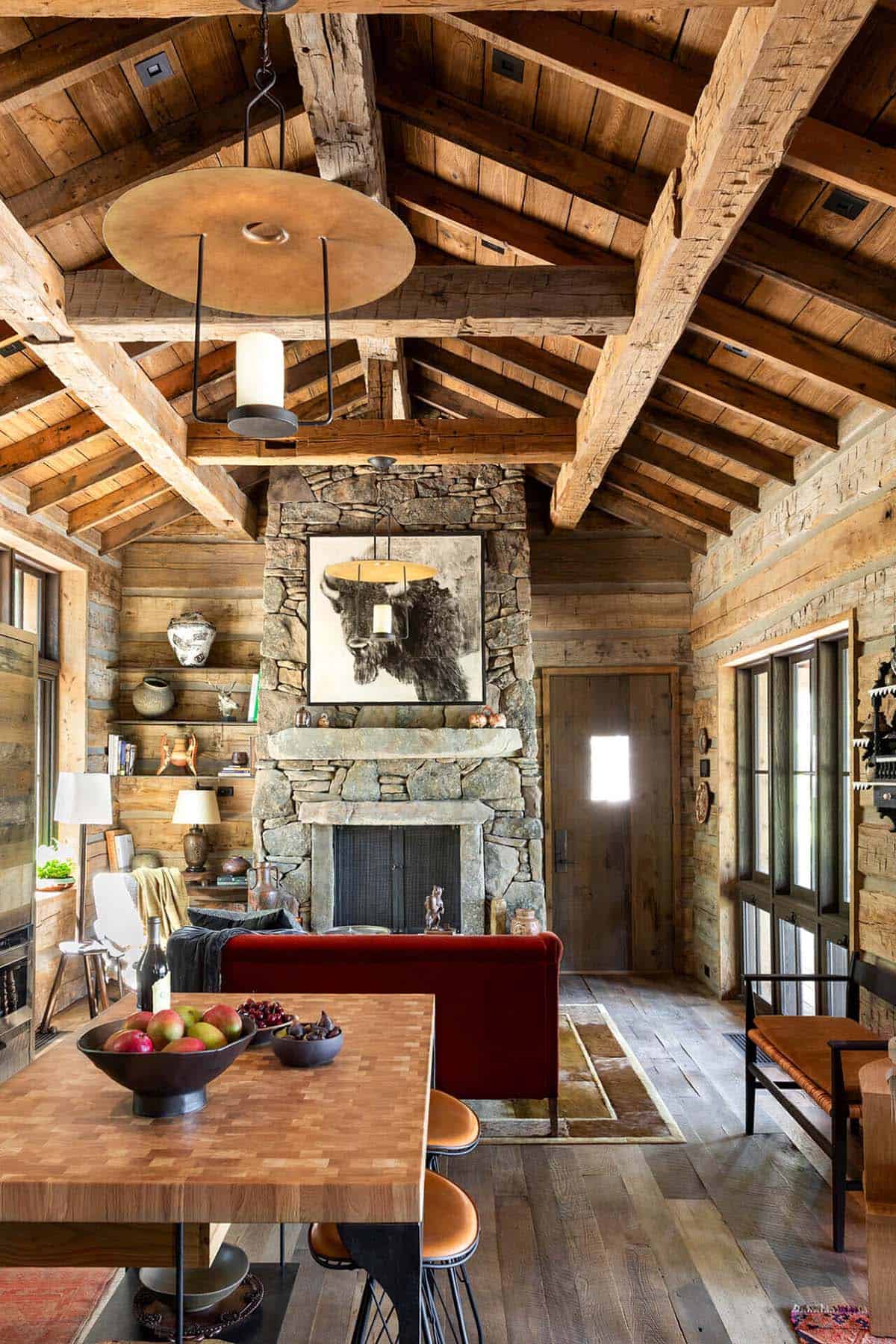 Rustic living room with stone fireplace and exposed wood beams