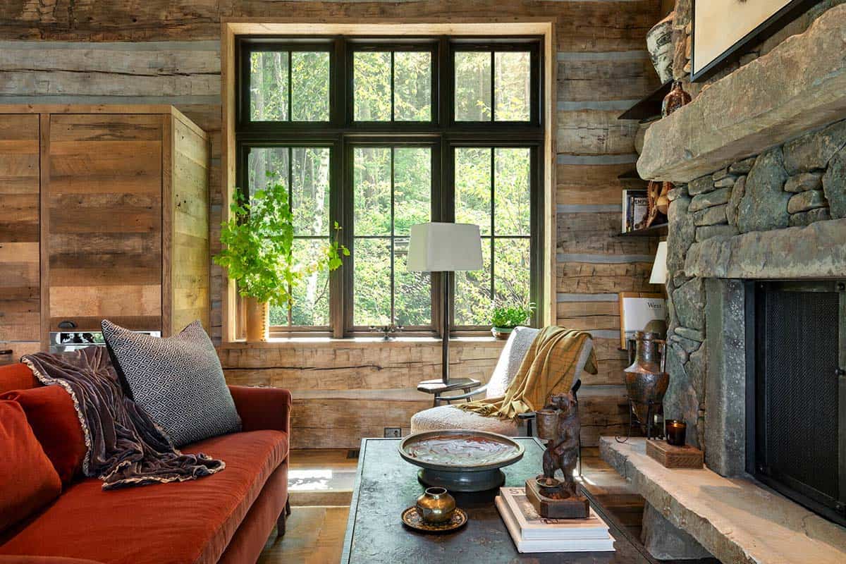 Cozy living area with red sofa and stone fireplace