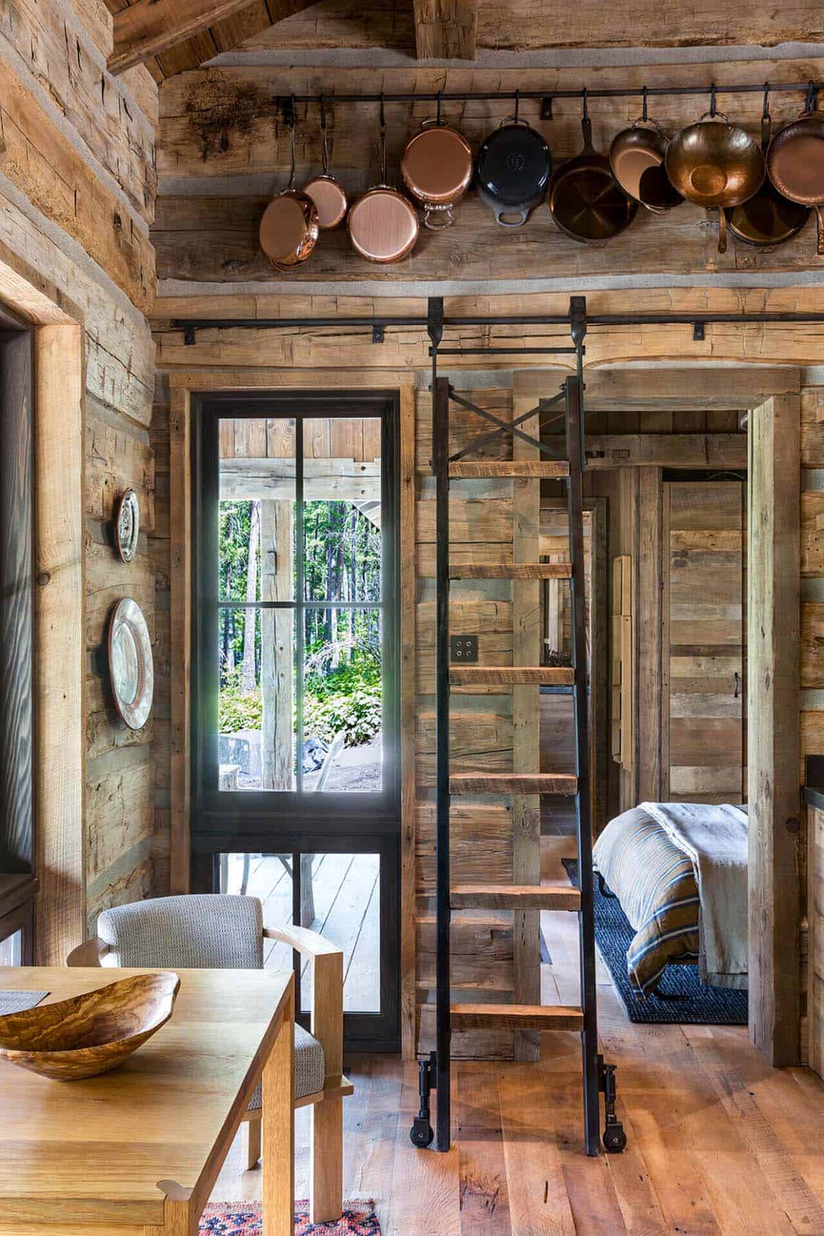 Kitchen nook with sliding barn door and ladder to loft