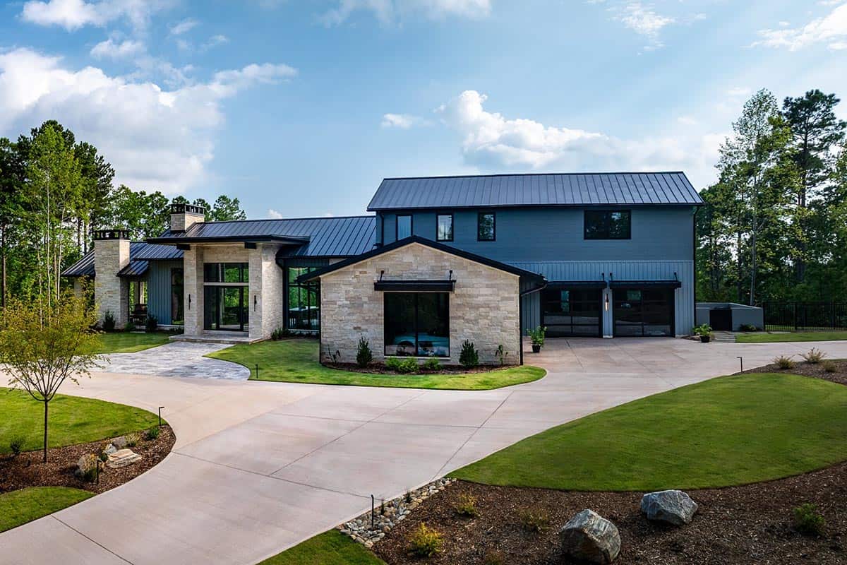 Contemporary two-story lake house exterior with stone accents and circular driveway