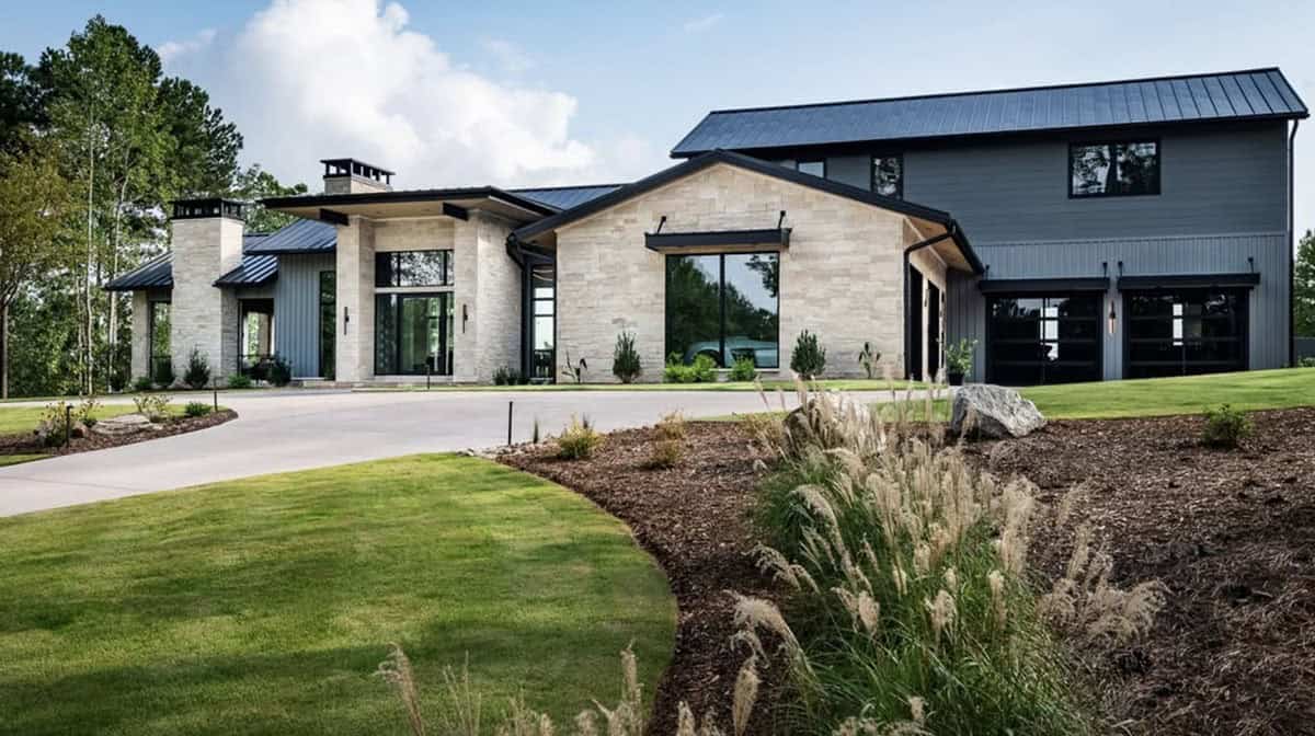 One-story stone and metal-roof home with garage and circular driveway