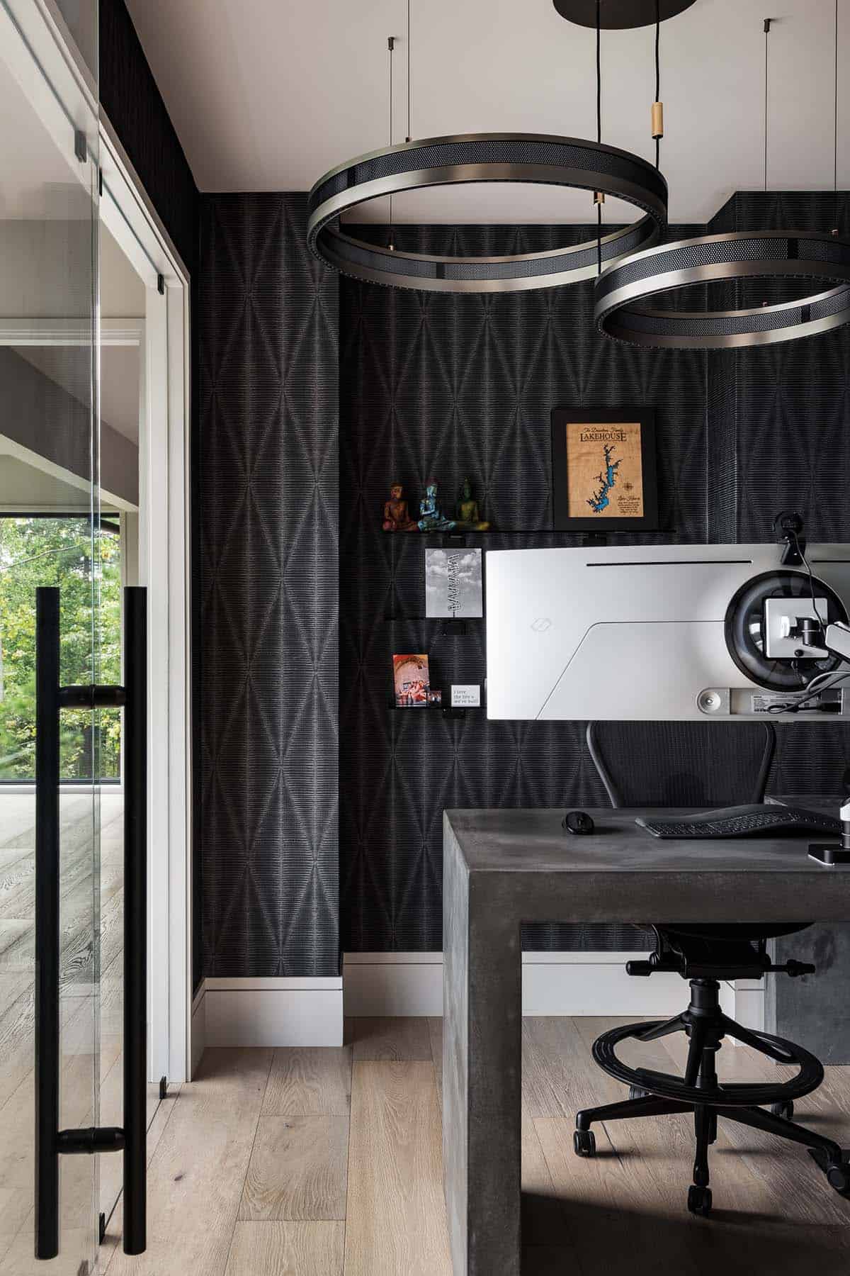 Home office nook with diamond-patterned wallpaper and concrete desk
