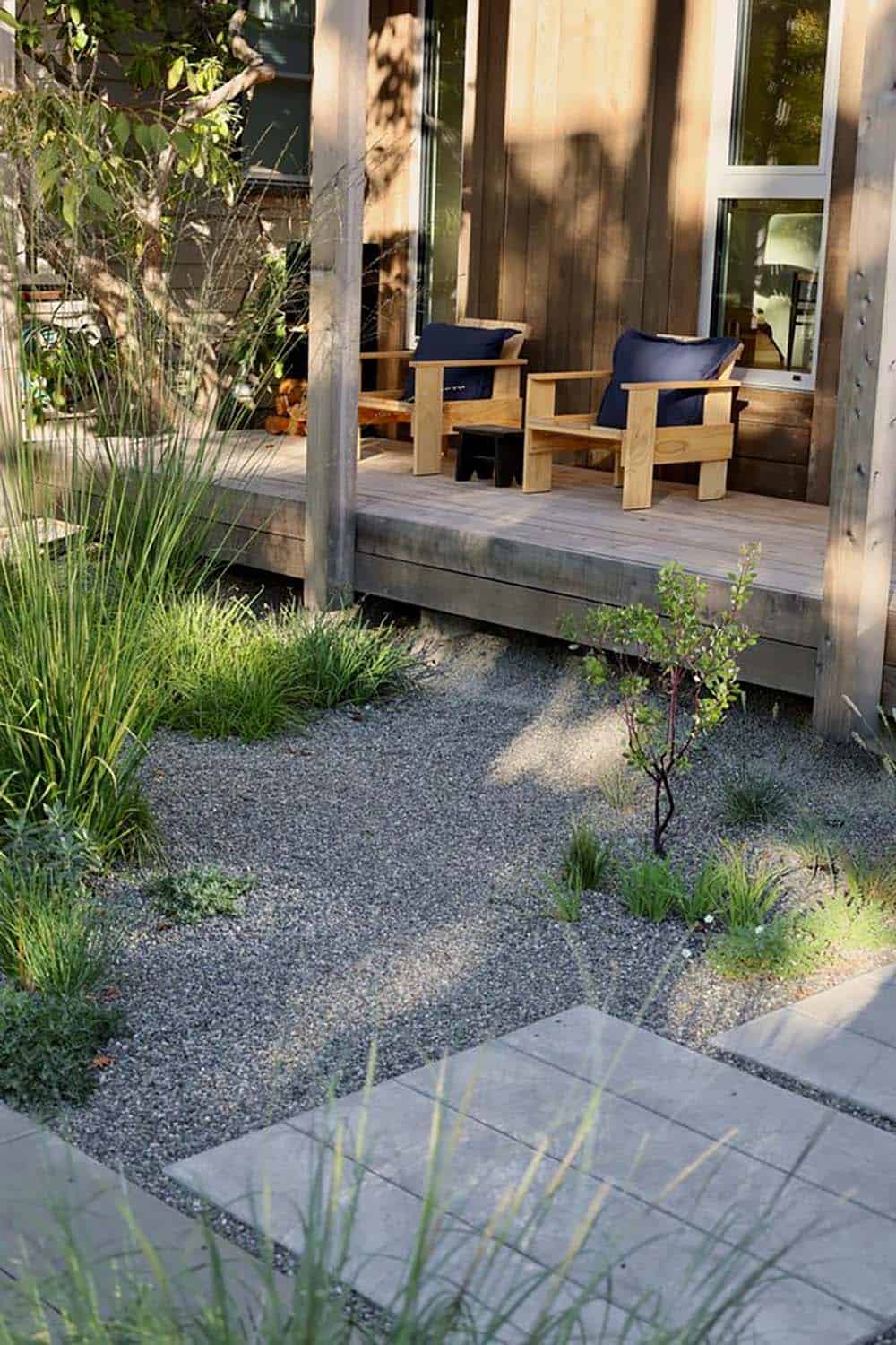 Rear garden with gravel, native plantings, and wood deck with custom outdoor chairs