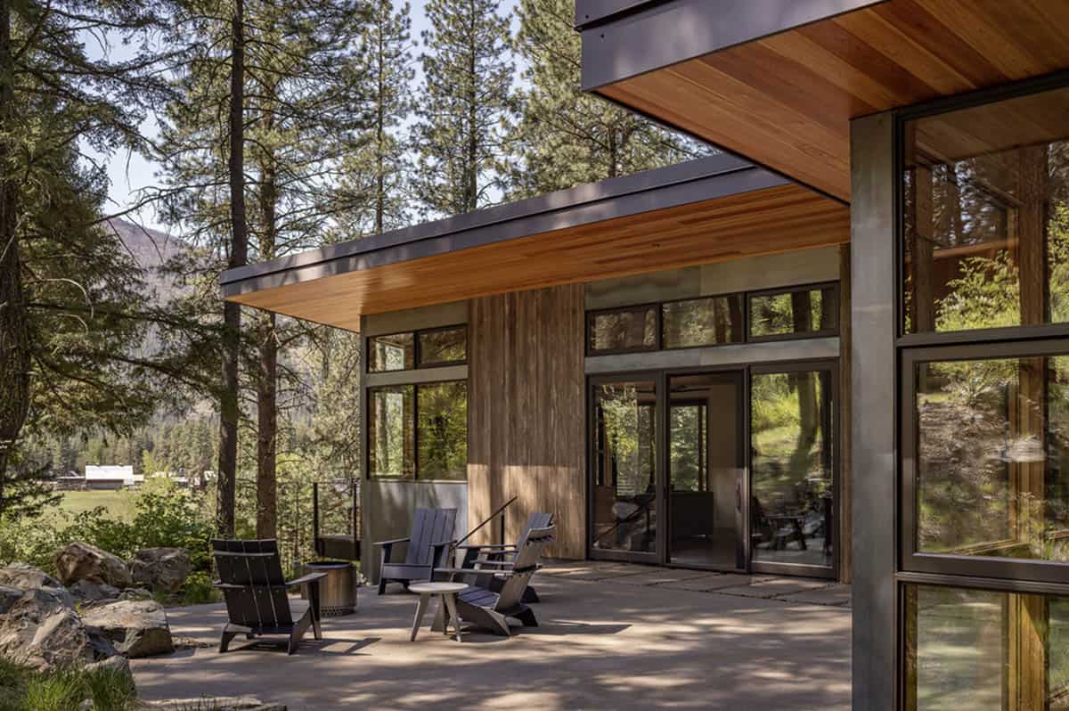 Covered patio with Adirondack chairs and floor-to-ceiling windows