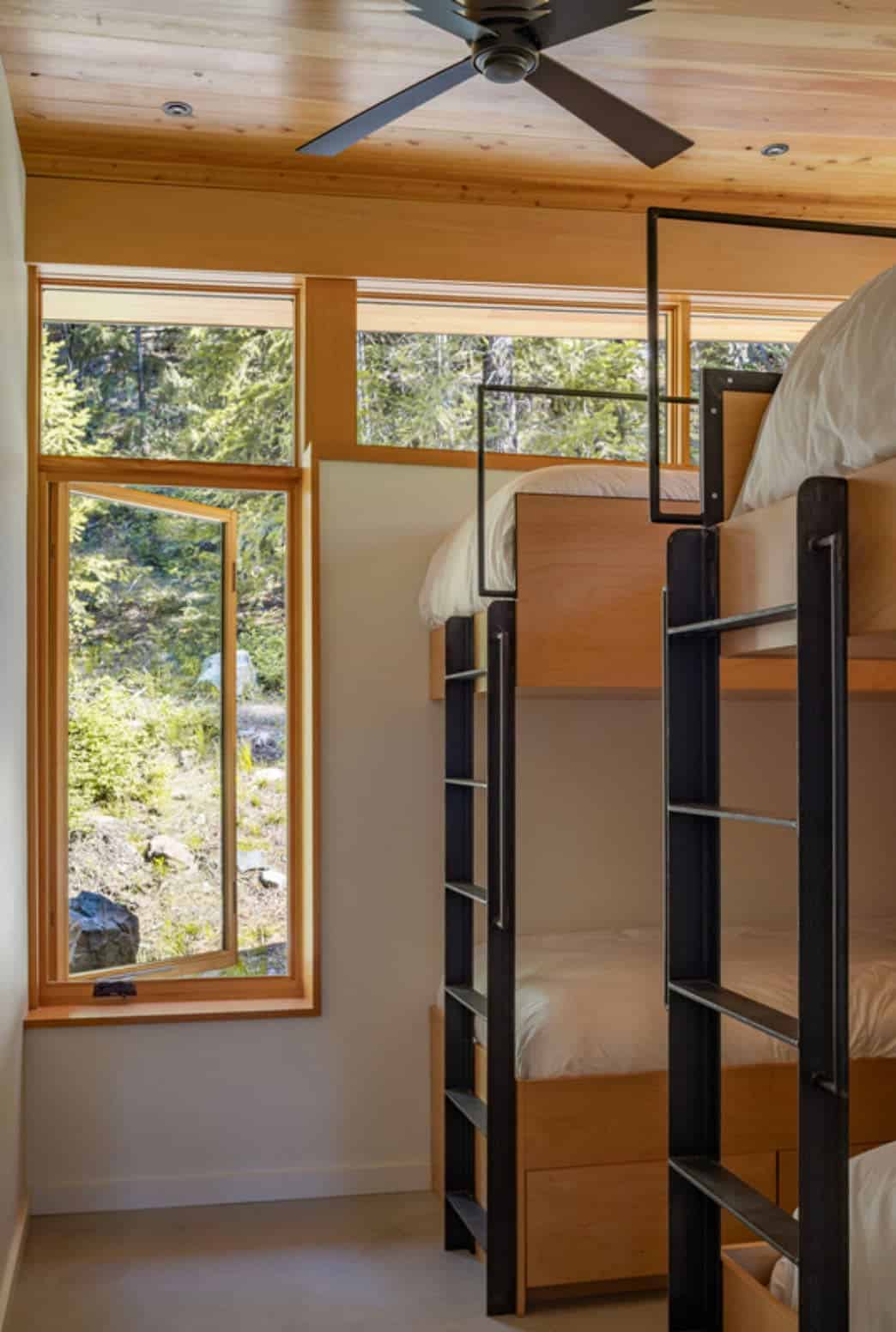Children's bedroom with custom steel bunk beds and forest views