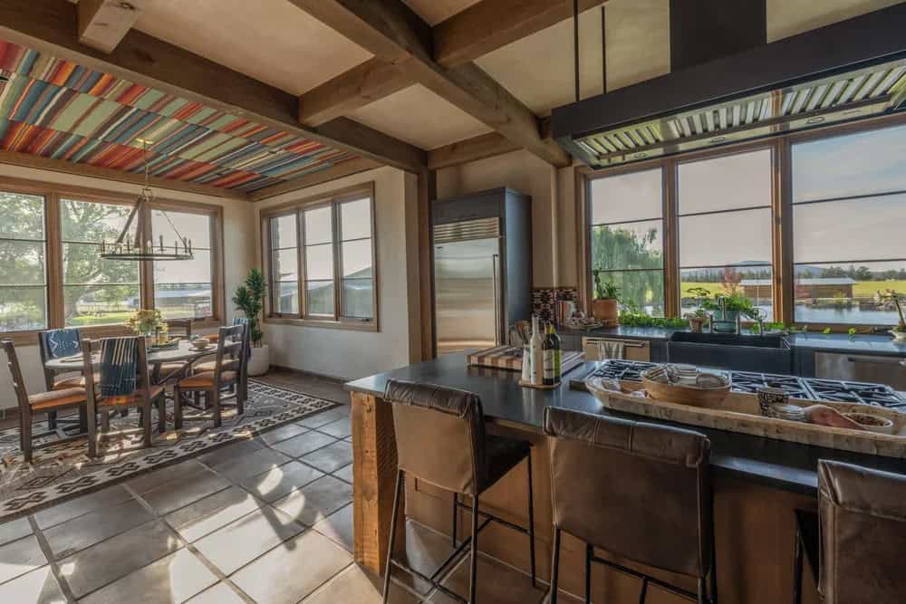 Kitchen and dining area with serape-patterned ceiling and farmhouse views