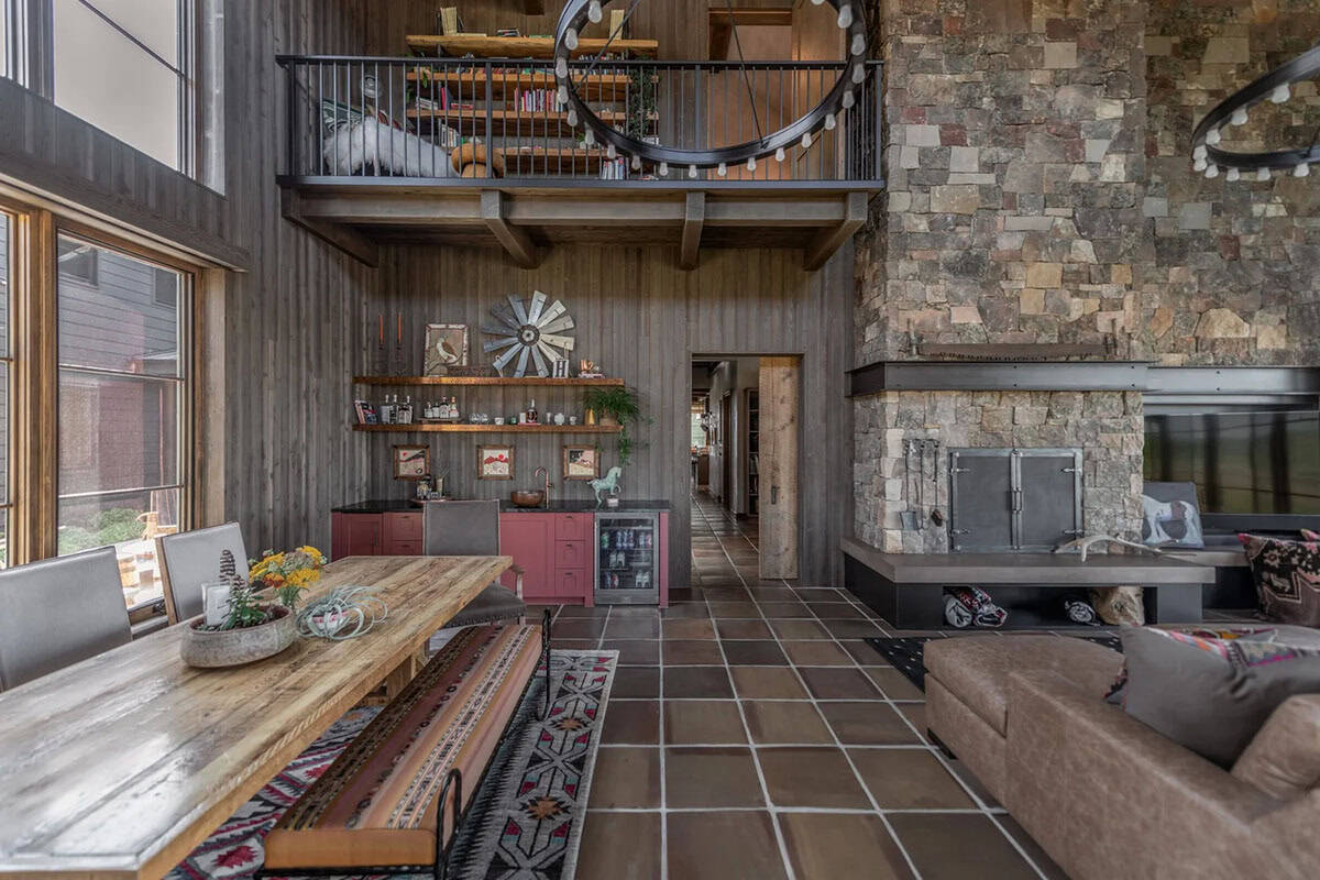 Two-story great room with stone fireplace and open loft above