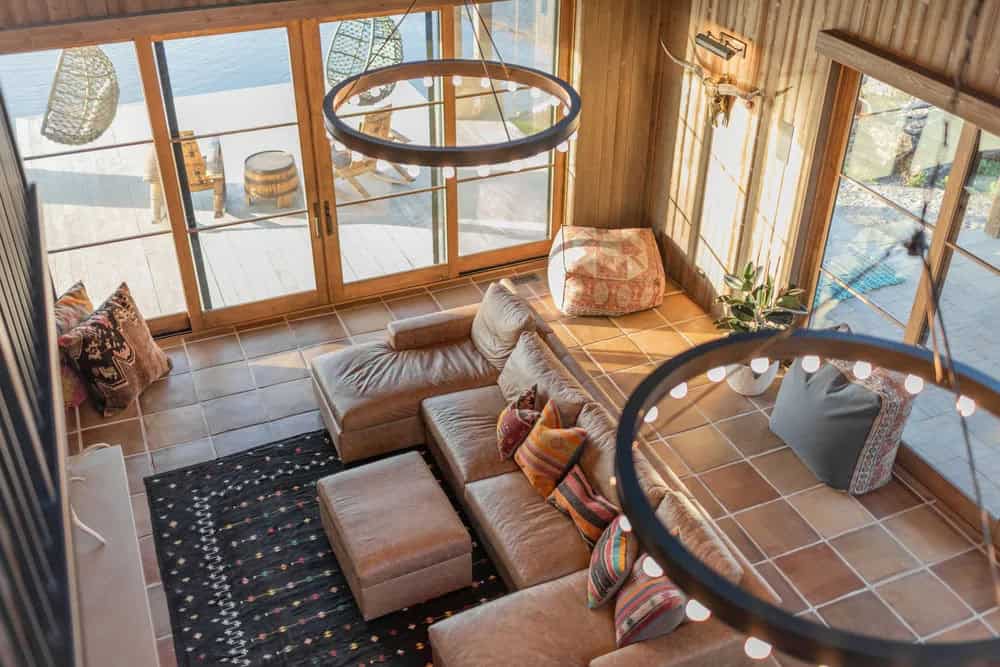 Overhead view of sunken living room with sectional sofa and circular light fixtures
