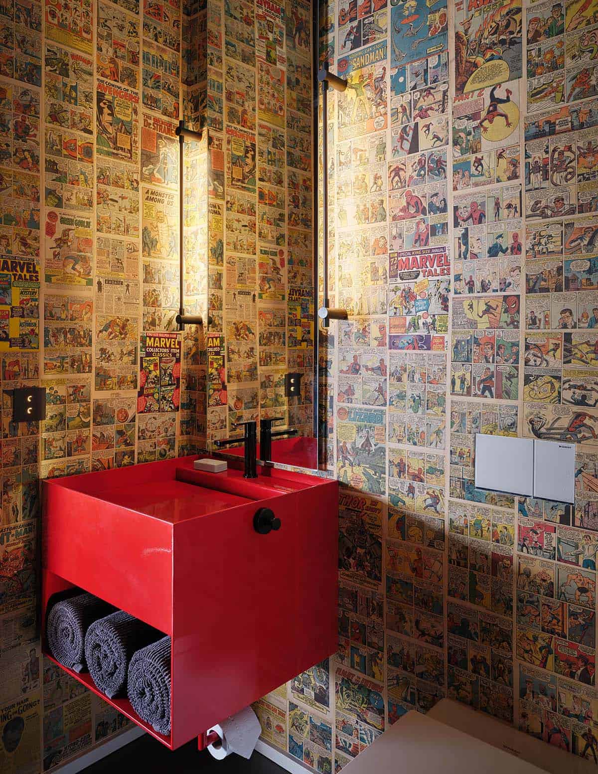 Powder room with vintage comic book wallpaper and a bold red floating sink