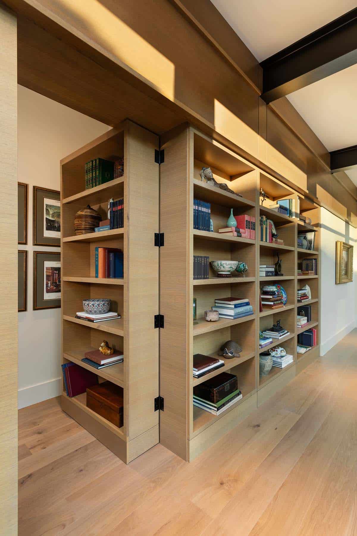 Hidden door concealed within built-in oak bookcase wall